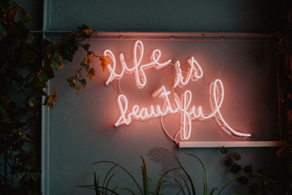 An image of a life is beautiful neon sign which is part of finding joy in the ordinary.