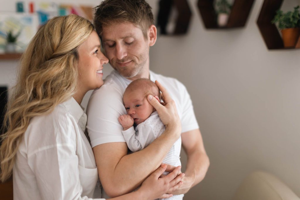 Young family with new baby during newborn photography session