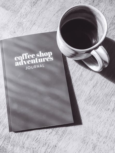 A blank coffee journal titled "Coffee Shop Adventures Journal."