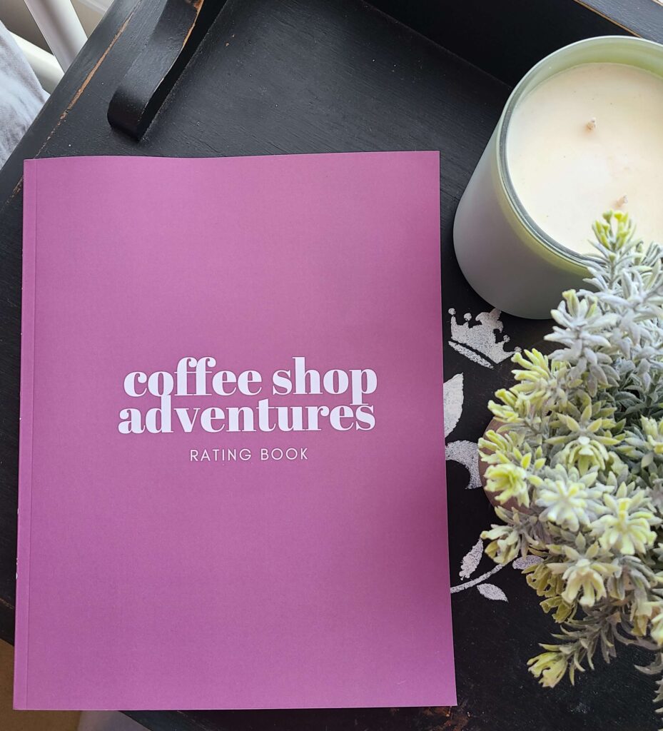 A picture of a purple version of the Coffee Shop Adventures book which makes a great Valentine's coffee gift!