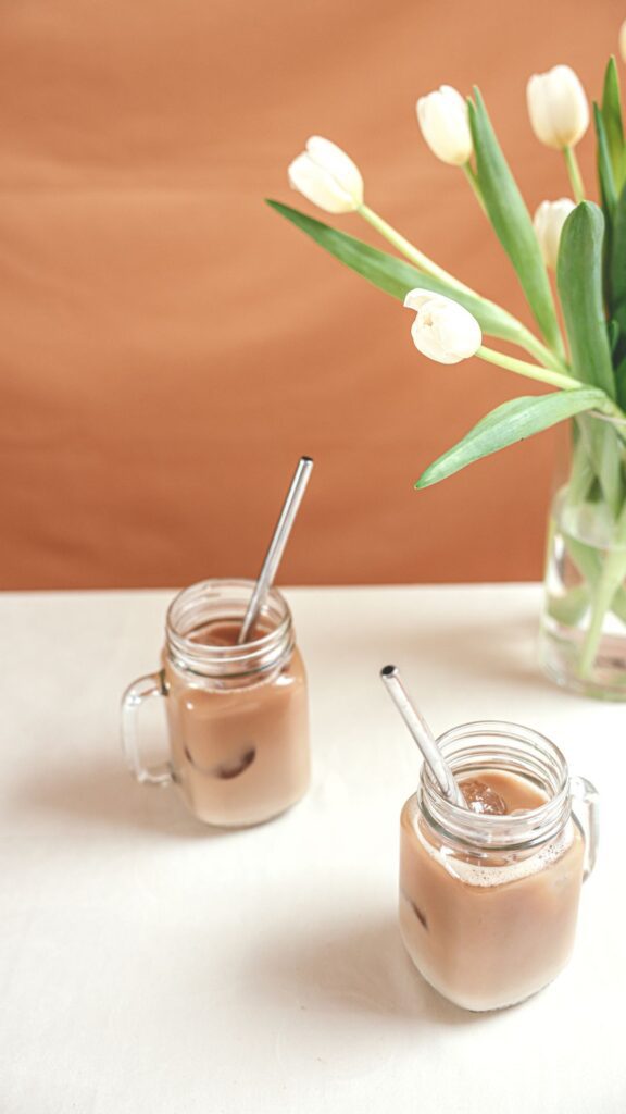 A couple of iced coffee glasses with straws.