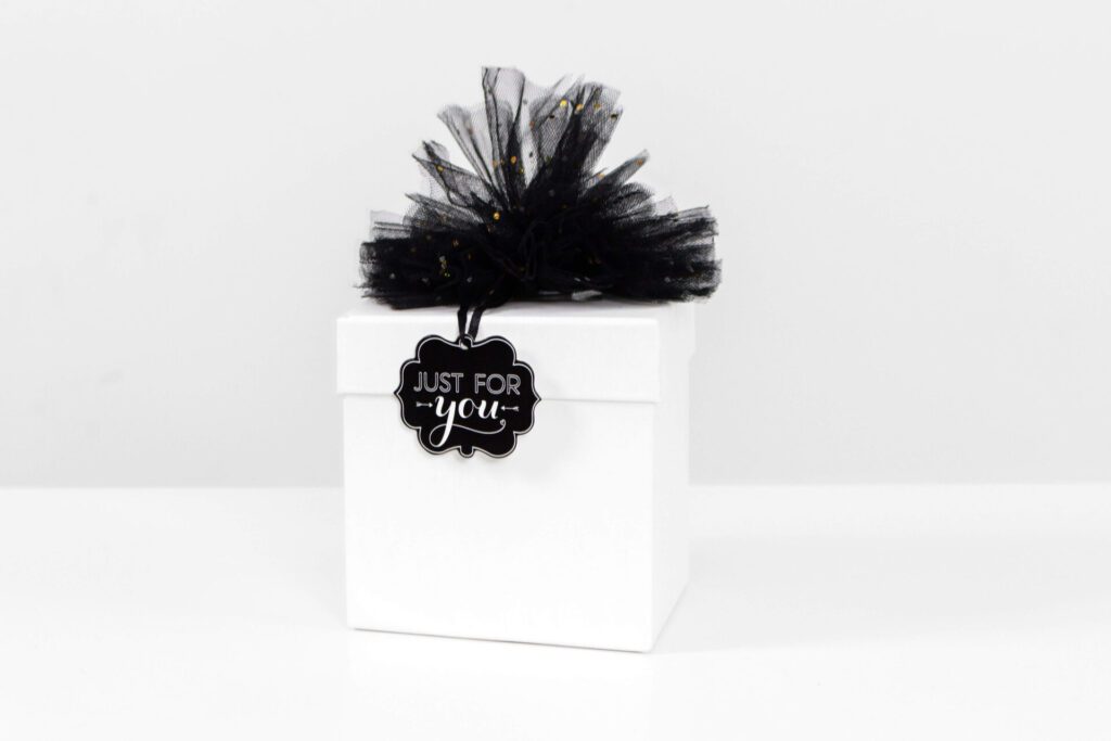 A white gift box that has a tag reading "Just for you."