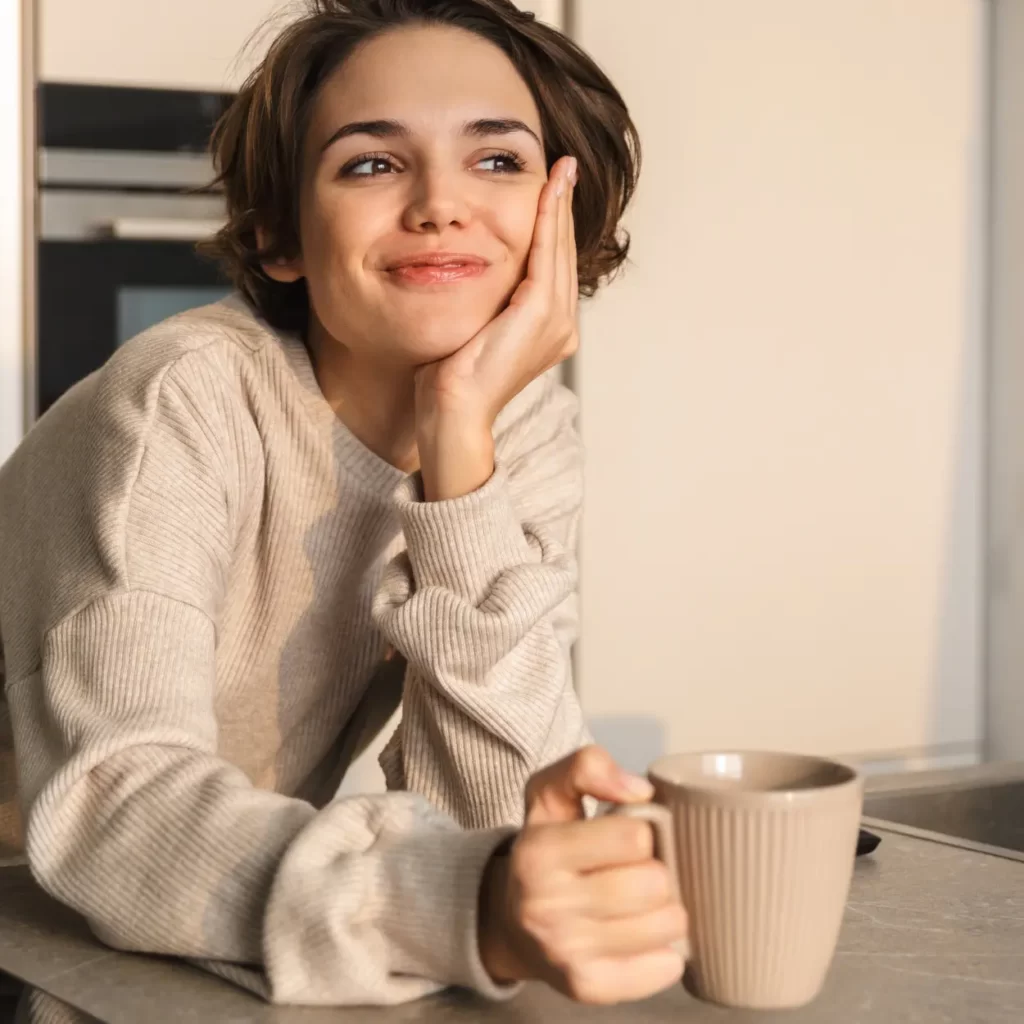 A woman drinking coffee with flaxseed.