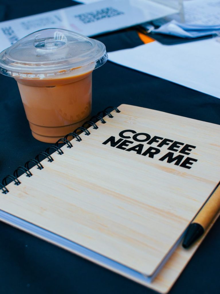 Coffee next to a coffee journal.