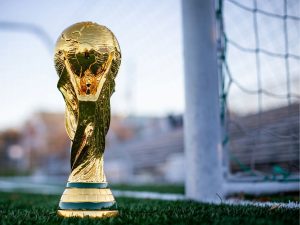 World Cup in front of a soccer goal.